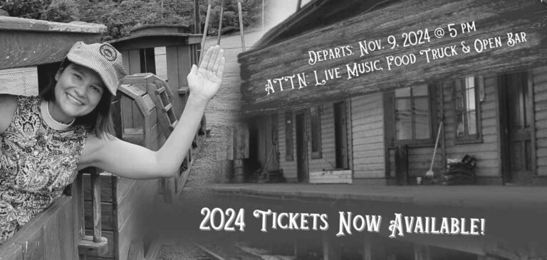 Rev Jill waves from a wooden train pulling into a train station. Sign reads: Departs: Nov. 9, 2024 @ 5 pm ATTN: Live Music, Food Truck & Open Bar. 2024 Tickets Now Available!